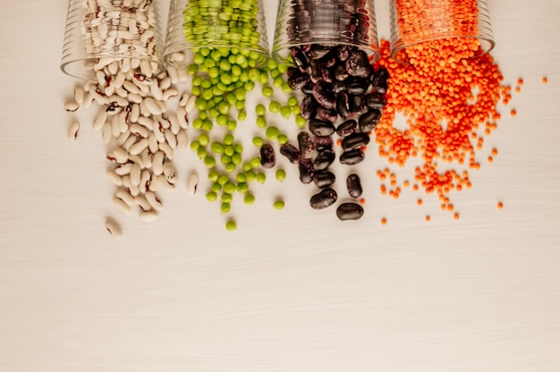 Set of different dried legumes in glasses