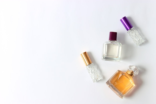 Set of different perfumes on a light background