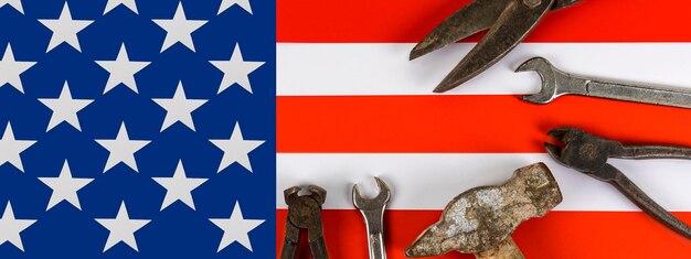 A set of different repair tools in American flag background Happy Labor Day concept International celebration Banner Copy space Flat lay