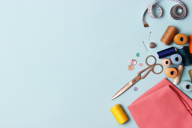 Photo set of different sewing accessories on a colored background closeup