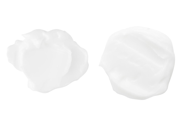 A set of different strokes of white cream on a white background