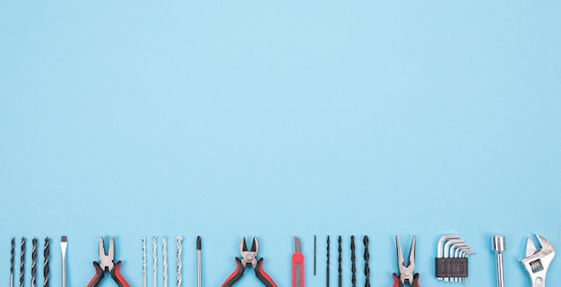 Set of different tools on blue background