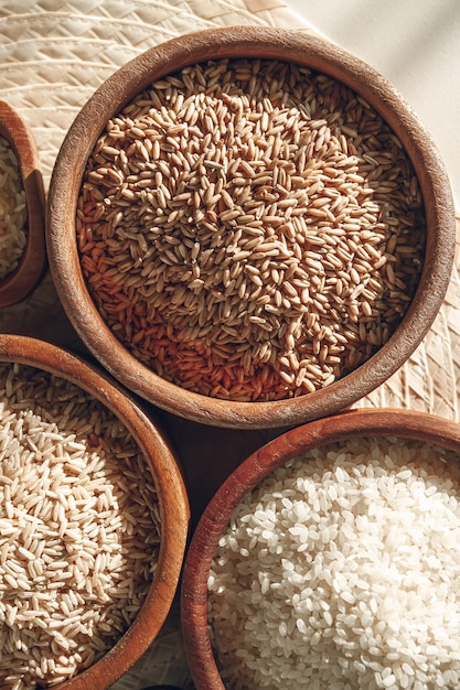 Set of different types of rice and cereals in wooden bowls