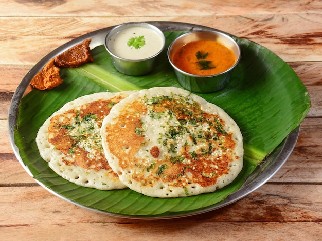 Set Dosa a south Indian traditional and popular Breakfast served with chutney and sambar over a rustic wooden background selective focus