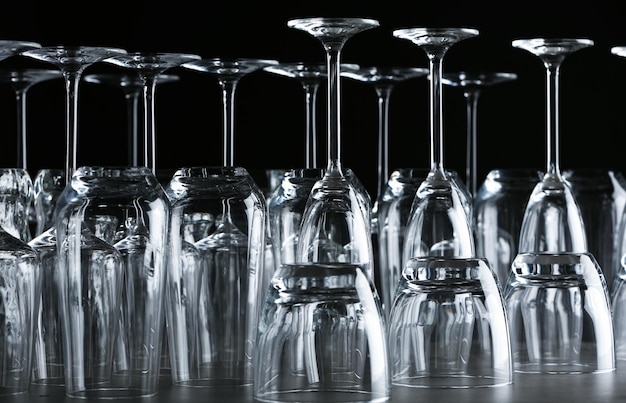 Set of empty glasses on table against black background