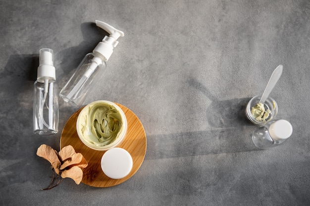 Set of empty jars for cosmetics on a gray table. Flatlay