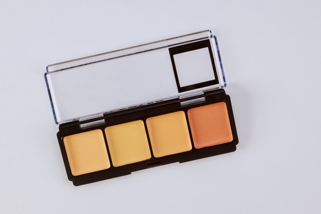 Set of eyeshadows in pastel beige colors pallet brown matte shadows, closeup of makeup product on an isolated white table