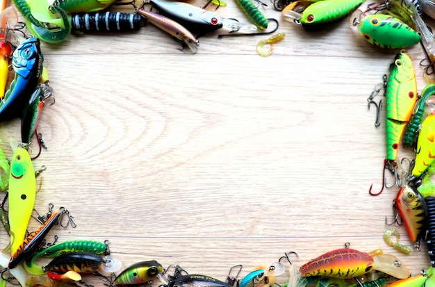 Set of fishing lures banner on a wooden light background