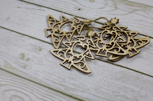 Photo set of flat wooden toys in the shape of a christmas tree tied together lie on a white background