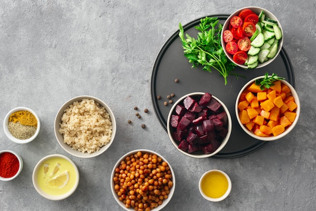 Set food for cooking healthy vegetarian food. Spiced chickpeas, baked pumpkin and beets, quinoa and vegetables top view