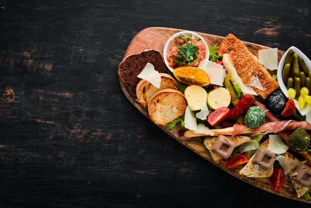 Photo a set of food snacks of italian cuisine on a wooden background top view free copy space