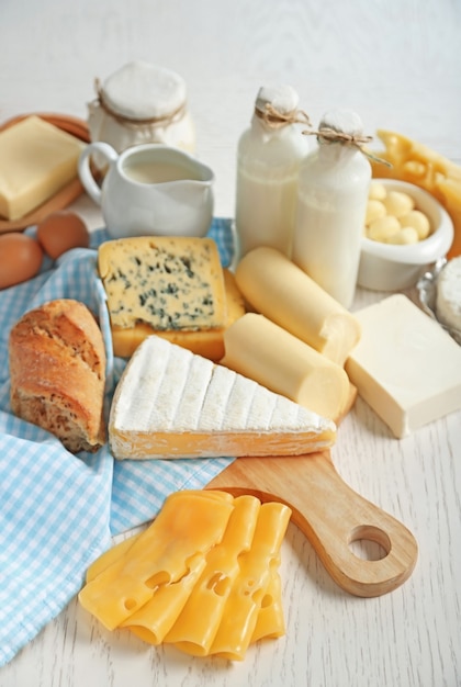 Set of fresh dairy products on white wooden table