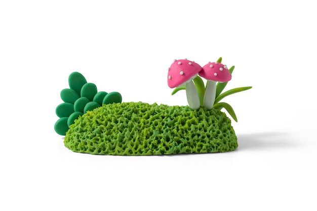 Set of garden bushes with fuchsia mushrooms made from plasticine. Natural landscape design elements