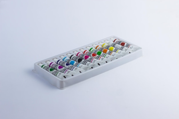 A set of gouache paints on a white background Colorful paints School inventory