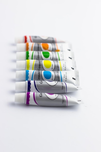 A set of gouache paints on a white background Colorful paints School inventory