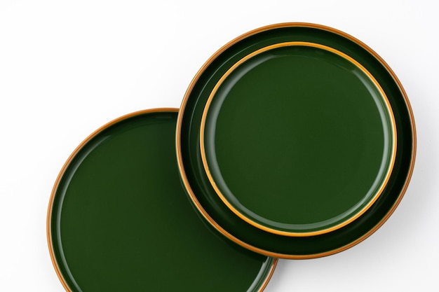 A set of green ceramic plates on a white background Top view