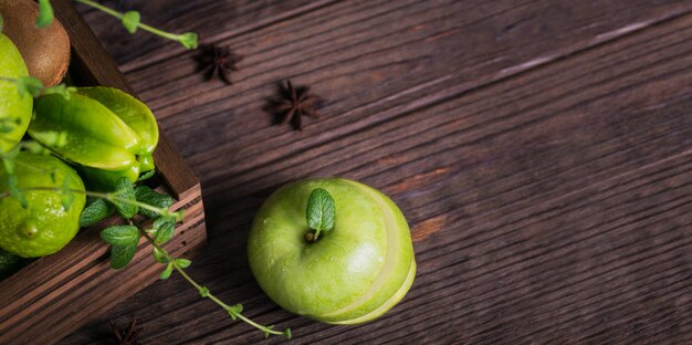 Set of green fruits for healthy diet and detox: apple, lime, kiwi, mango, carambola and mint