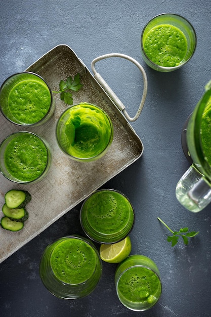 Set of green smoothies on a dark background