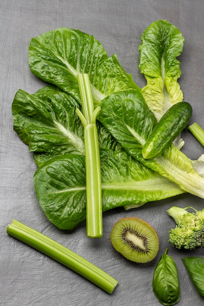 Set of green vegetables Lettuce celery stalks half kiwi and cucumber