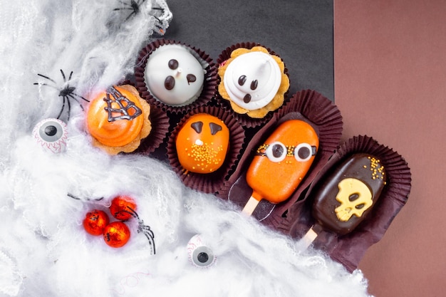 Set of Halloween sweets on black and brown background