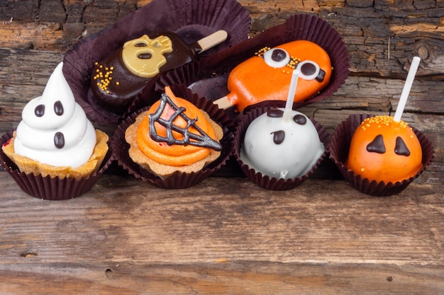 Set of Halloween sweets on old wooden background