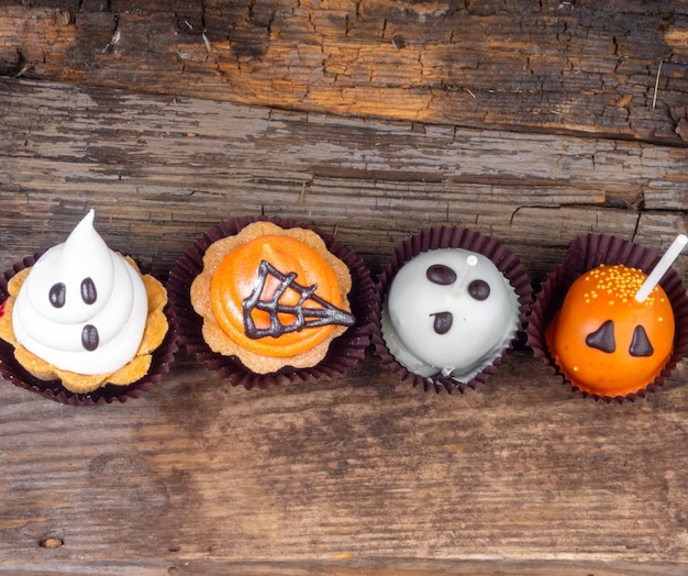 Set of Halloween sweets on old wooden background