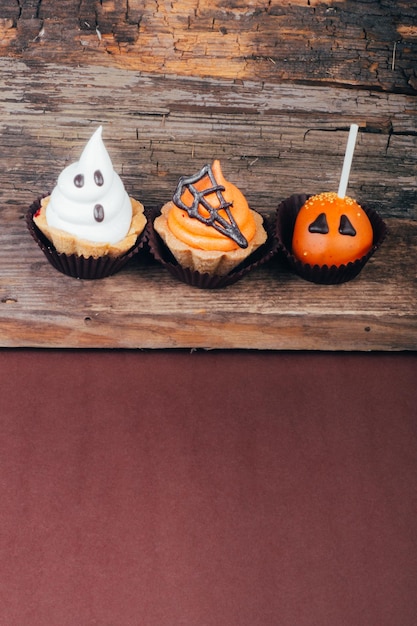 Set of Halloween sweets on old wooden background