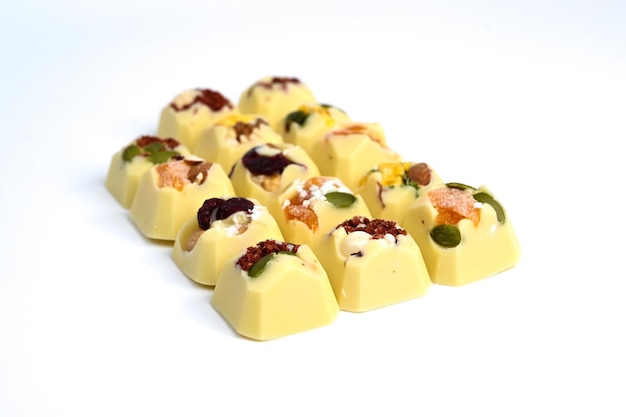 Set of handmade bonbons on white background Exclusive handcrafted chocolate candies with fruit and nuts filling