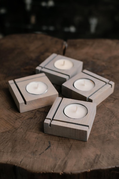 A set of handmade grey wooden candlesticks