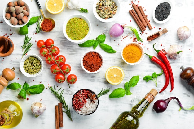 Set of Indian spices basil and herbs on a white wooden background Top view Free space for text