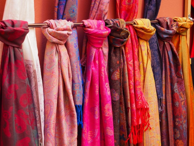 Set of large scarves of different colors displayed for sale on the street