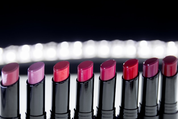 Set of matte Lipstick in red and natural colors on white and black background. 