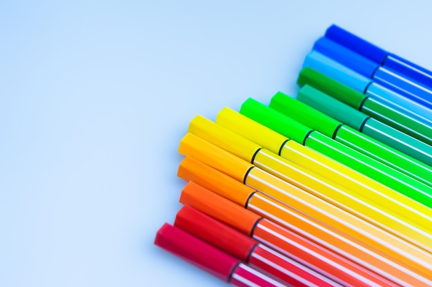 Set of multi-color felt-tip pens on blue