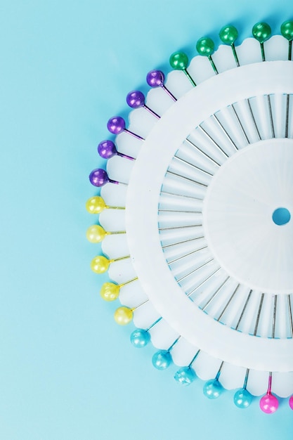 A set of multicolored needles pins in a round platform