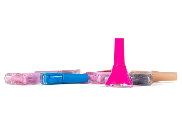 a set of nail polish of different colors in glass bottles isolated on a white background