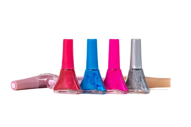 a set of nail polish of different colors in glass bottles isolated on a white background