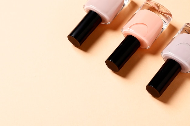 Set of nail polishes on a pink background