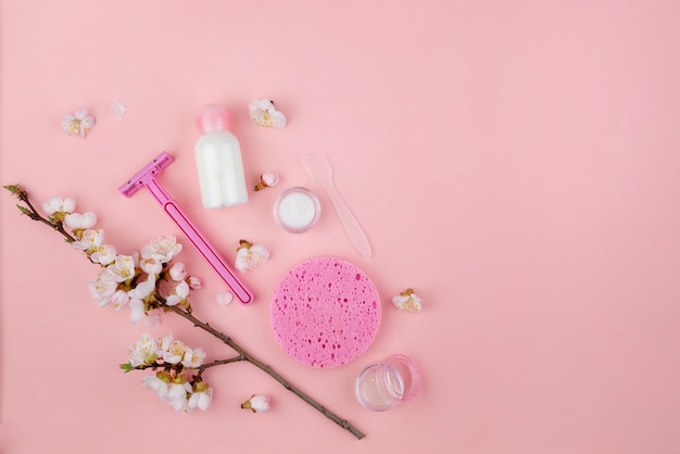 Set of natural cosmetics and Spa products on a pink wall. Flat lay with space for text.