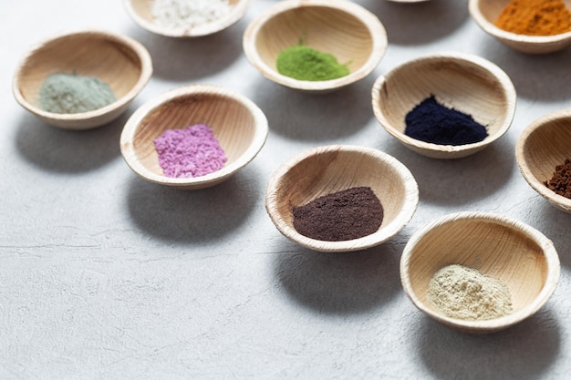 Set of natural pigment powder from herbs in small bowls