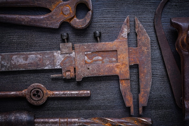 Set of old rusted tools on vintage board