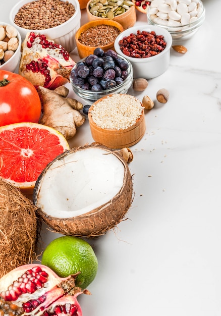 Set of organic healthy diet food, superfoods - beans, legumes, nuts, seeds, greens, fruit and vegetables.. white background copy space