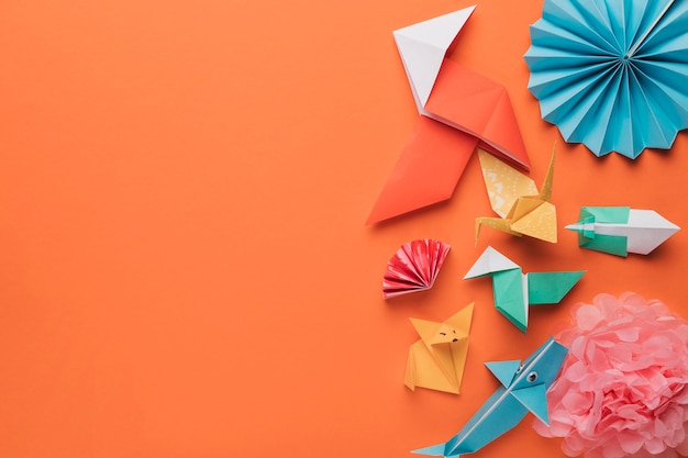 Set of origami paper art craft on bright orange surface