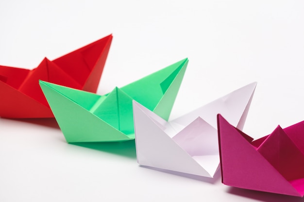 Set of origami paper boats. Leadership and business concept