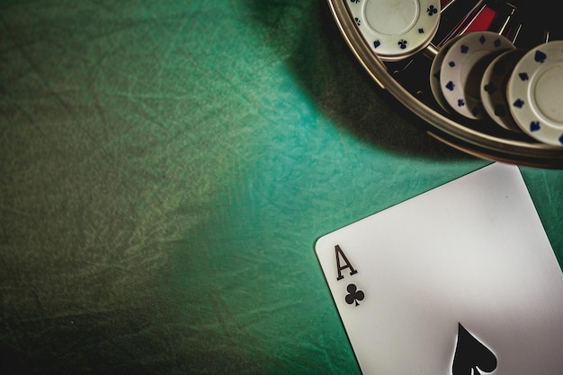 a set of poker chips and a pair of aces on a table