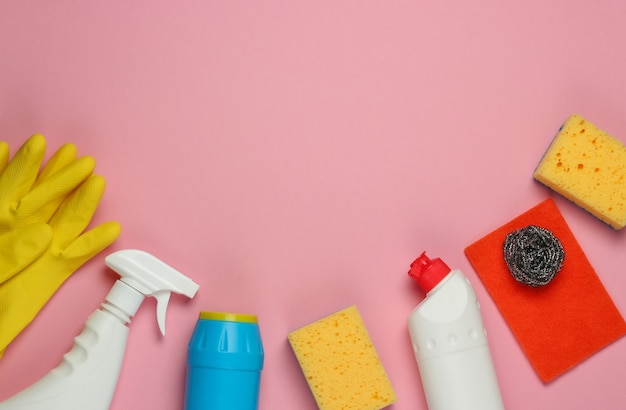 Set of products for cleaning the house on pink pastel background. Top view. Copy space