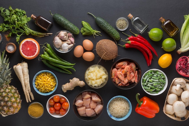 Set of products for the preparation of Thai cooking dishes on a black background, top view