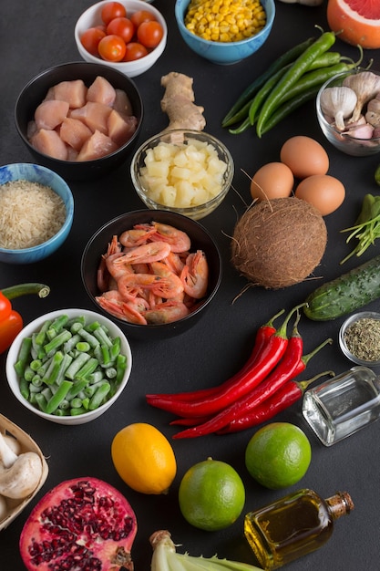 Set of products for the preparation of Thai cooking dishes on a black background, top view