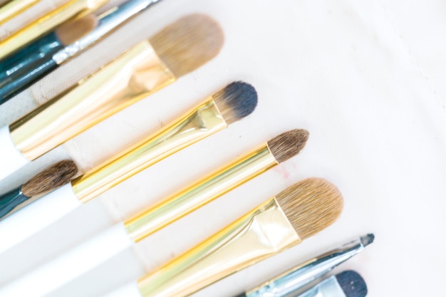 Set of professional makeup brushes on a white background Closeup