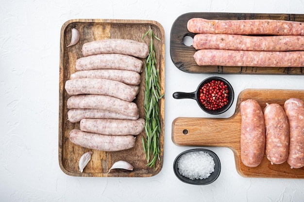 Set of raw pork beef and chicken sausages flat lay on white background