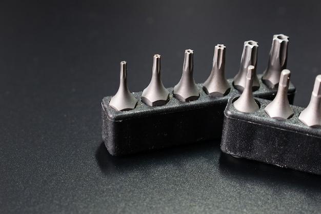 set of screwdriver heads on black table